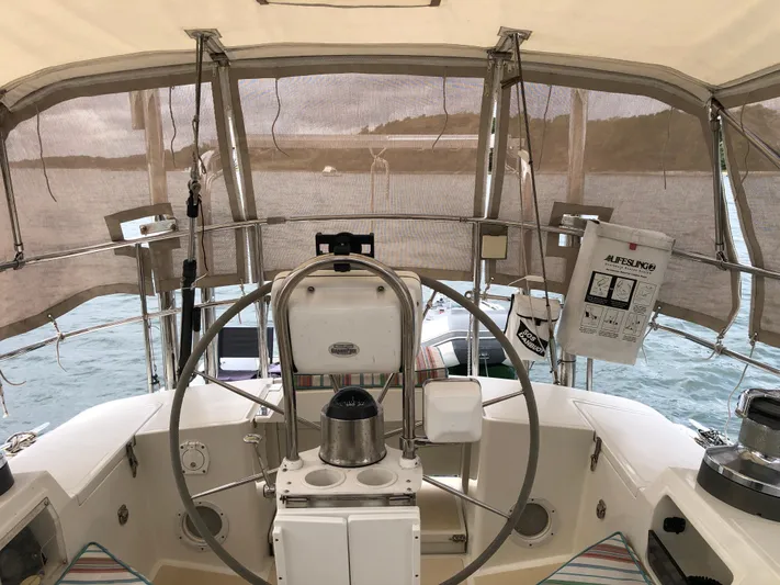 Ibis Yacht Photos Pics Cockpit of 2008 Outbound 46 sailboat with steering wheel and navigation equipment.