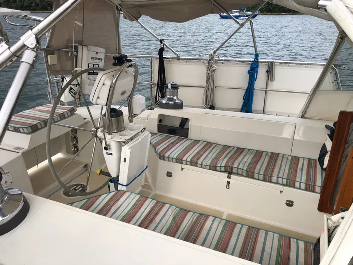 Ibis Yacht Photos Pics Cockpit of 2008 Outbound 46 sailboat with striped seating and steering wheel.