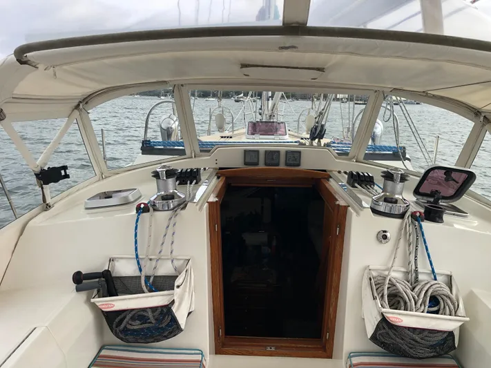Ibis Yacht Photos Pics Cockpit of 2008 Outbound 46 sailboat with ropes and winches, overlooking the sea.