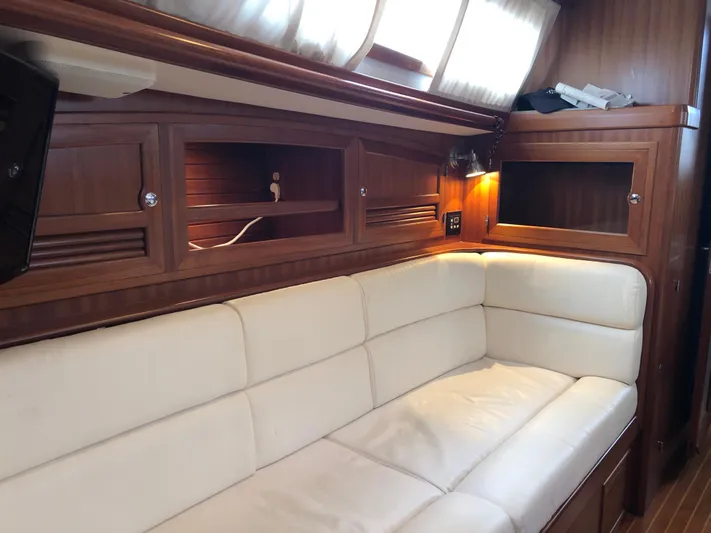 Ibis Yacht Photos Pics Luxurious interior of 2008 Outbound 46 yacht with white leather seating and wooden cabinetry.