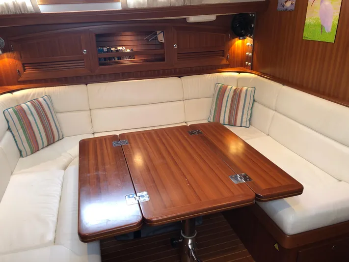 Ibis Yacht Photos Pics Luxurious interior of 2008 Outbound 46 yacht with wooden table and cushioned seating.