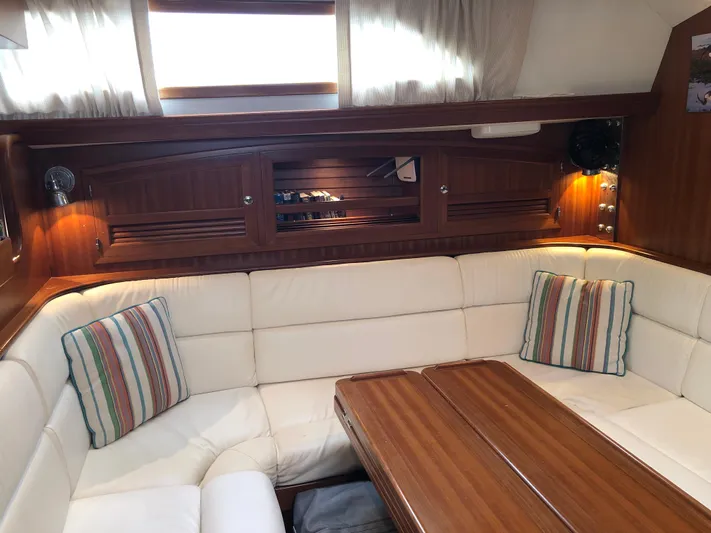 Ibis Yacht Photos Pics Luxurious interior of 2008 Outbound 46 yacht with plush seating and wooden table.