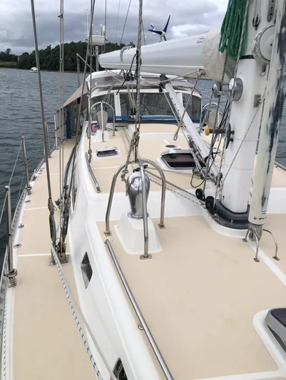 Ibis Yacht Photos Pics Outbound 46 sailboat deck, 2008 model, anchored on calm water with overcast skies.