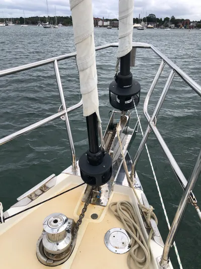 Ibis Yacht Photos Pics Bow of 2008 Outbound 46 sailboat with ropes and winch, docked in a marina.