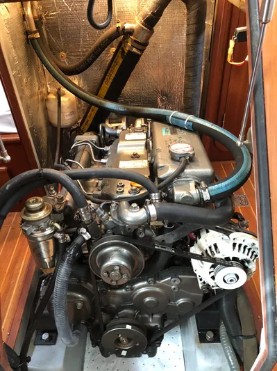 Ibis Yacht Photos Pics Engine compartment of a 2008 Outbound 46 sailboat, showcasing mechanical components and hoses.