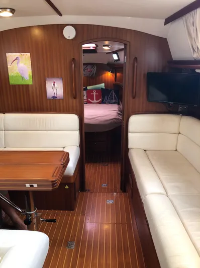 Ibis Yacht Photos Pics Interior of 2008 Outbound 46 yacht with wood paneling, white seating, and cozy cabin.