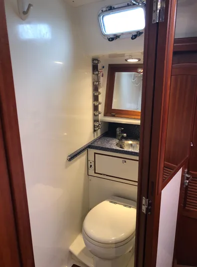 Ibis Yacht Photos Pics Compact bathroom in 2008 Outbound 46 yacht with sink, toilet, and mirror.