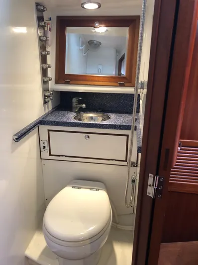 Ibis Yacht Photos Pics Compact bathroom in 2008 Outbound 46 yacht with sink, mirror, and toilet.