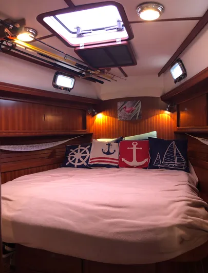 Ibis Yacht Photos Pics Cozy cabin interior of 2008 Outbound 46 sailboat with nautical-themed pillows.