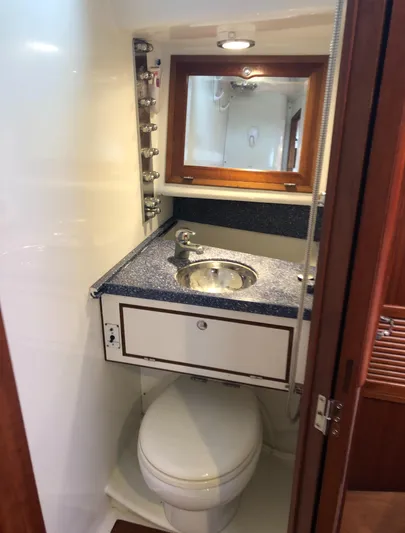 Ibis Yacht Photos Pics Compact bathroom in 2008 Outbound 46 yacht with sink, mirror, and toilet.