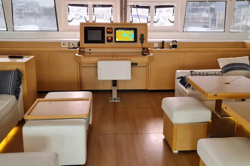 Sicilia Yacht Photos Pics Luxurious interior of 2013 Lagoon 620 yacht with modern navigation equipment and comfortable seating.
