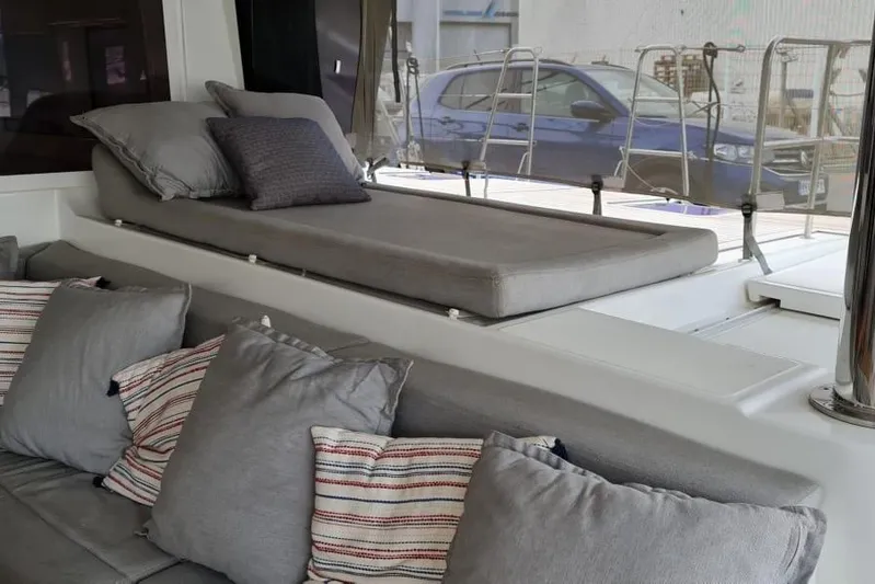 Sicilia Yacht Photos Pics Luxurious seating area on 2013 Lagoon 620 yacht with cushions and sunbed.