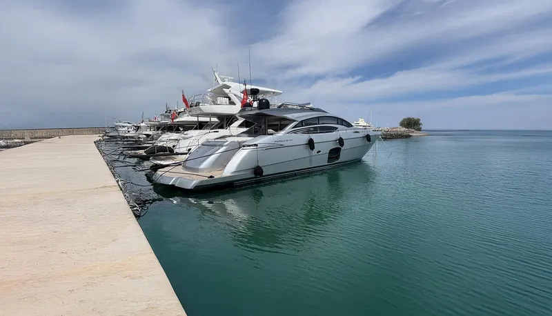 Dolce Vita Yacht Photos Pics Luxury Pershing 74 yacht docked at marina, calm waters, clear sky, 2011 model.