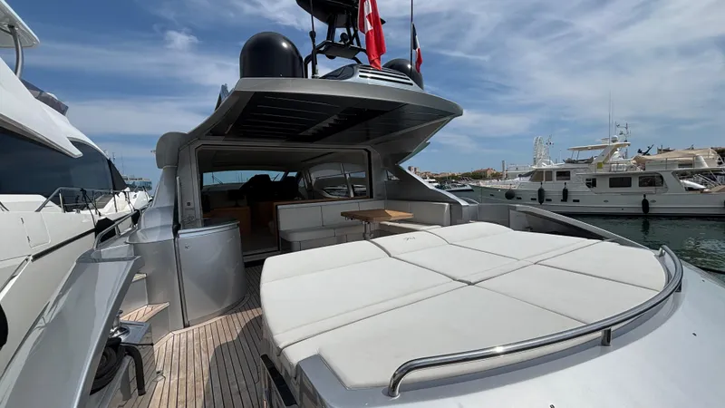 Dolce Vita Yacht Photos Pics Luxurious 2011 Pershing 74 yacht with spacious deck and modern design in marina setting.