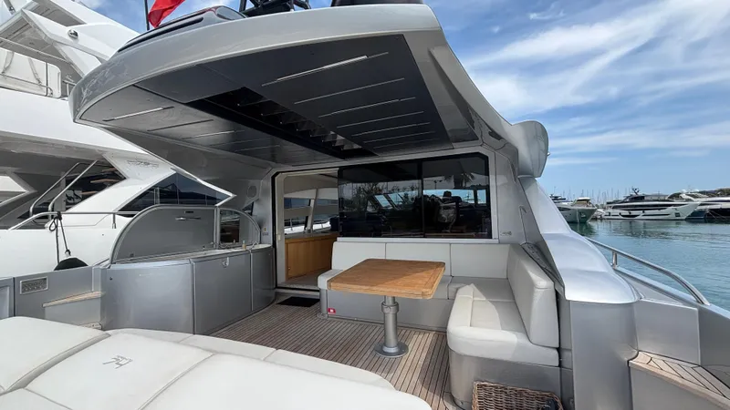 Dolce Vita Yacht Photos Pics Luxurious 2011 Pershing 74 yacht with spacious outdoor seating and sleek design in marina.