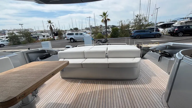 Dolce Vita Yacht Photos Pics Luxurious 2011 Pershing 74 yacht deck with seating and table, docked at marina.