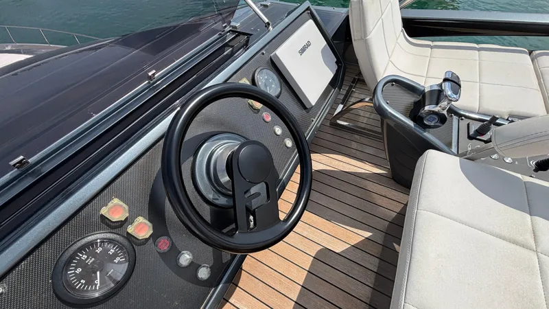 Dolce Vita Yacht Photos Pics Steering wheel and controls of a 2011 Pershing 74 yacht on teak deck.