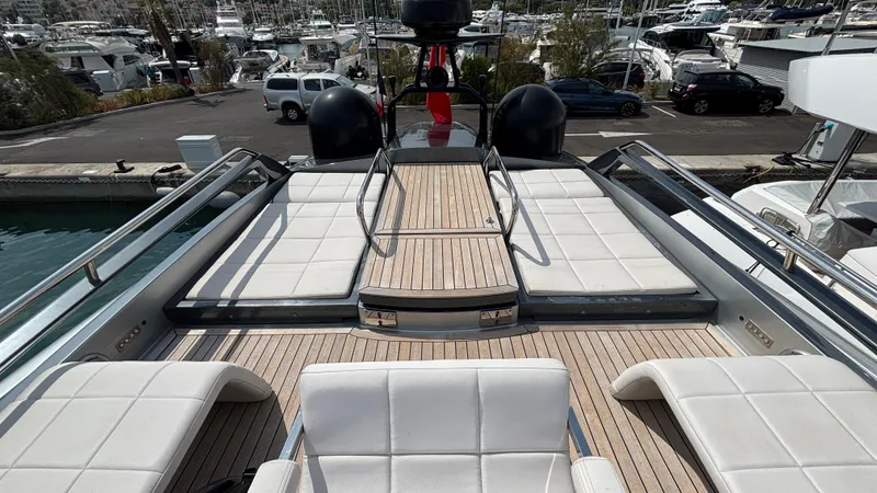 Dolce Vita Yacht Photos Pics Luxurious 2011 Pershing 74 yacht deck with white seating and marina view.