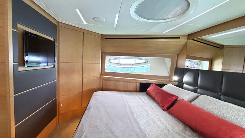 Dolce Vita Yacht Photos Pics Luxurious bedroom interior of 2011 Pershing 74 yacht with modern design and elegant furnishings.