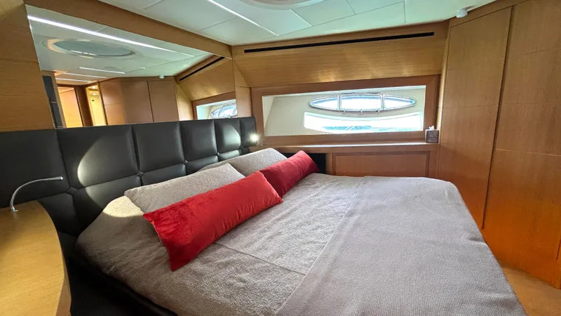 Dolce Vita Yacht Photos Pics Luxurious bedroom interior of 2011 Pershing 74 yacht with modern design and red accents.