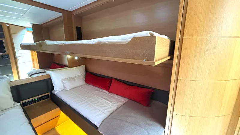 Dolce Vita Yacht Photos Pics Interior of 2011 Pershing 74 yacht with cozy bunk beds and wooden finish.