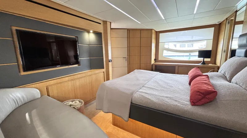 Dolce Vita Yacht Photos Pics Luxurious bedroom interior of 2011 Pershing 74 yacht with modern decor and large window.