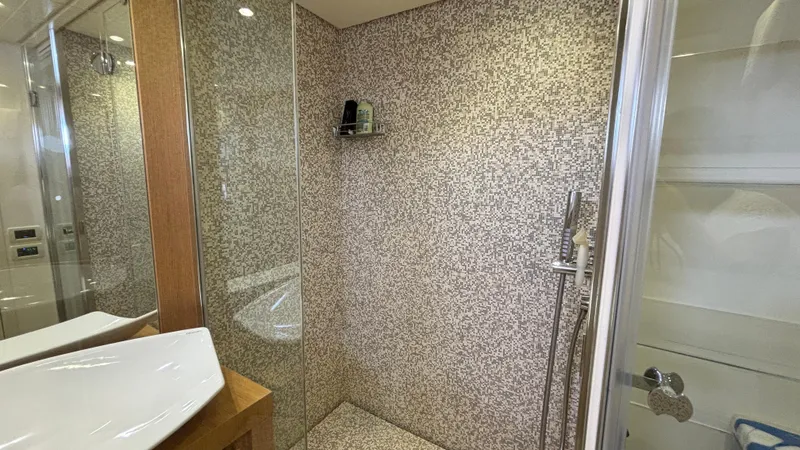 Dolce Vita Yacht Photos Pics Luxurious bathroom with mosaic-tiled shower in a 2011 Pershing 74 yacht.