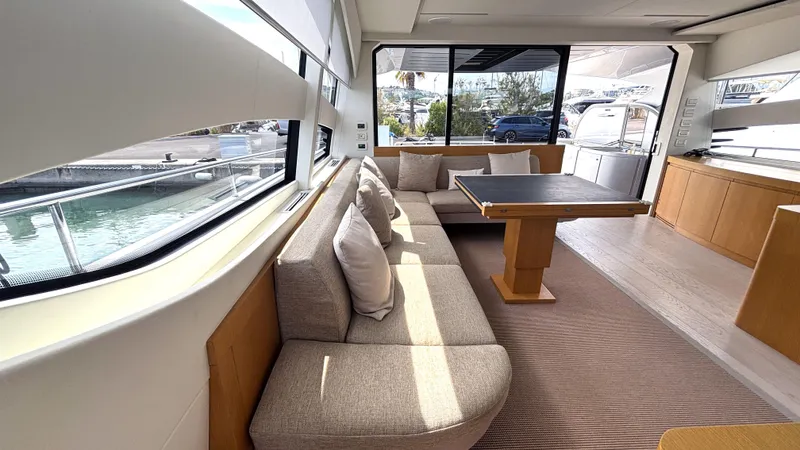 Dolce Vita Yacht Photos Pics Luxurious interior of a 2011 Pershing 74 yacht with elegant seating and large windows.