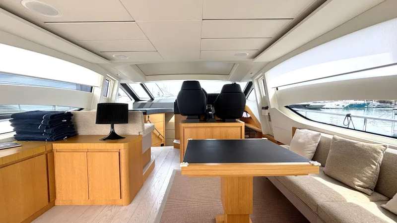 Dolce Vita Yacht Photos Pics Luxurious interior of a 2011 Pershing 74 yacht with modern furnishings and panoramic windows.