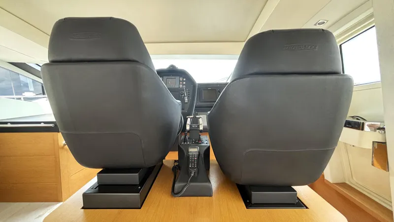 Dolce Vita Yacht Photos Pics Interior helm of 2011 Pershing 74 yacht with leather seats and control panel.