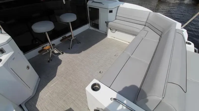 Stella Maris Yacht Photos Pics 2016 Cruisers Yachts 45 Cantius deck with gray seating and bar stools.