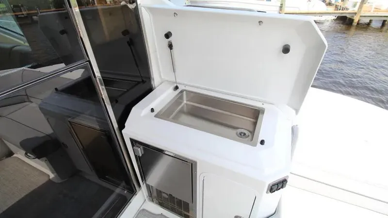 Stella Maris Yacht Photos Pics Outdoor sink and storage on 2016 Cruisers Yachts 45 Cantius boat deck.