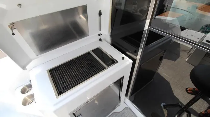 Stella Maris Yacht Photos Pics Outdoor grill area on 2016 Cruisers Yachts 45 Cantius, featuring stainless steel and modern design.