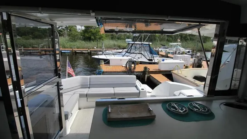 Stella Maris Yacht Photos Pics 2016 Cruisers Yachts 45 Cantius interior view, featuring spacious seating and dockside scenery.