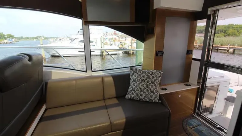 Stella Maris Yacht Photos Pics Interior of 2016 Cruisers Yachts 45 Cantius with waterfront view and modern seating.