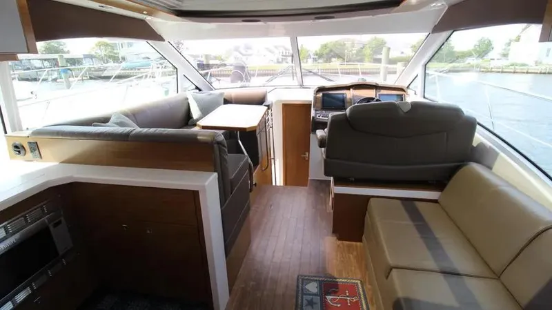 Stella Maris Yacht Photos Pics Interior of 2016 Cruisers Yachts 45 Cantius with modern seating and navigation area.