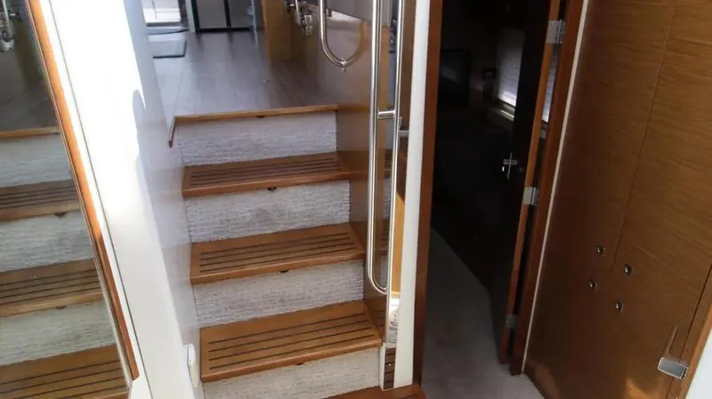 Stella Maris Yacht Photos Pics Staircase inside 2016 Cruisers Yachts 45 Cantius, featuring wooden steps and modern design.