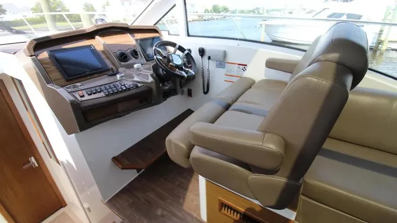 Stella Maris Yacht Photos Pics 2016 Cruisers Yachts 45 Cantius helm with leather seating and modern navigation controls.