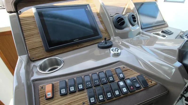 Stella Maris Yacht Photos Pics Control panel of 2016 Cruisers Yachts 45 Cantius with screens and switches.