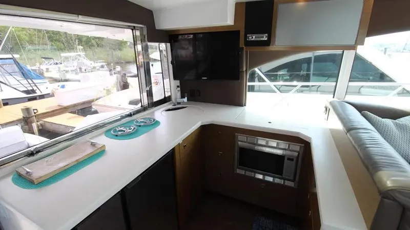 Stella Maris Yacht Photos Pics Interior of 2016 Cruisers Yachts 45 Cantius with modern kitchen and large windows.