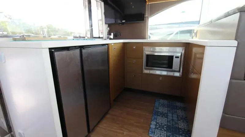 Stella Maris Yacht Photos Pics 2016 Cruisers Yachts 45 Cantius kitchen with modern appliances and wood flooring.