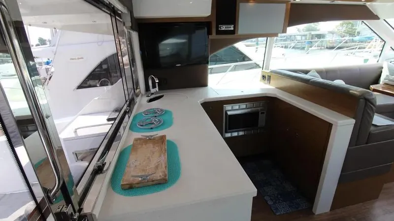 Stella Maris Yacht Photos Pics 2016 Cruisers Yachts 45 Cantius interior with modern kitchen and seating area.