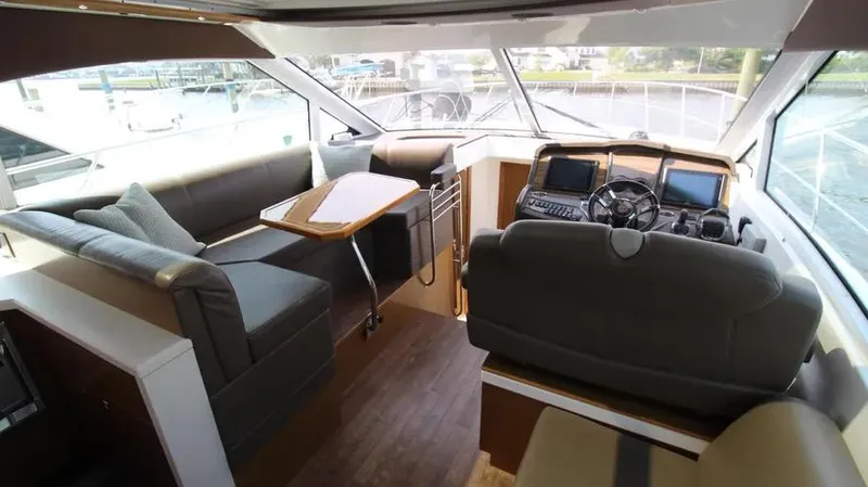 Stella Maris Yacht Photos Pics Interior of 2016 Cruisers Yachts 45 Cantius with modern helm and seating area.