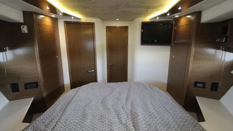 Stella Maris Yacht Photos Pics Luxurious 2016 Cruisers Yachts 45 Cantius cabin interior with modern wood finishes and cozy bedding.