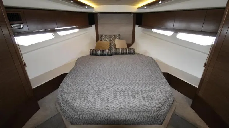 Stella Maris Yacht Photos Pics Luxurious bedroom interior of 2016 Cruisers Yachts 45 Cantius with modern design and cozy bedding.