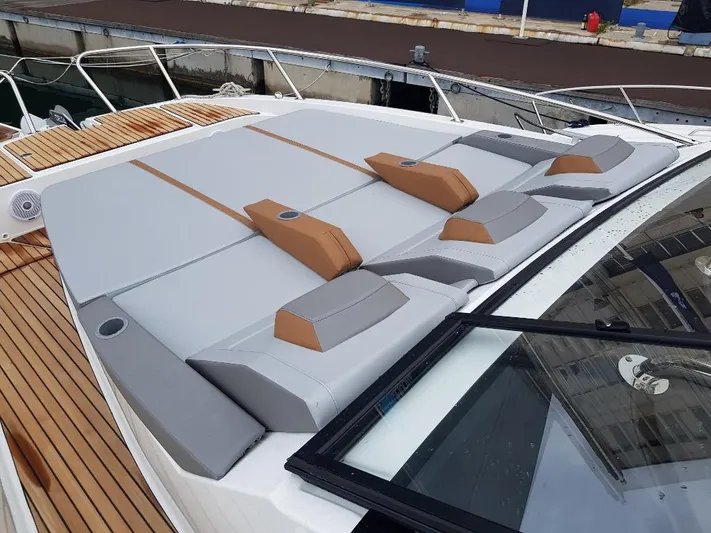 La Bella Vita Yacht Photos Pics Beneteau Flyer 10, 2020, cushioned sunbathing area, dockside background.