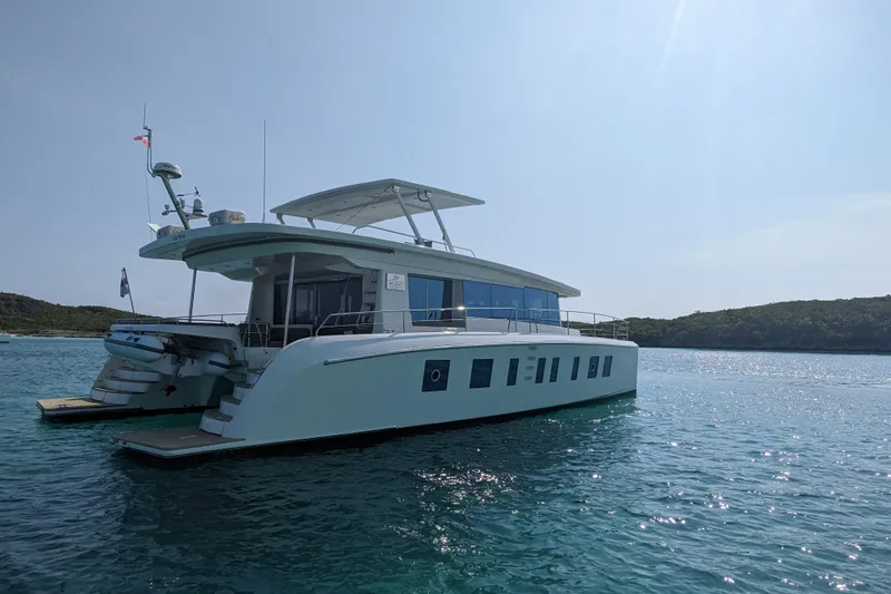 Silent Seven Yacht Photos Pics Silent 55 yacht from 2020 on calm blue waters, with scenic background.