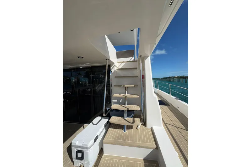 Silent Seven Yacht Photos Pics Staircase on Silent 55 yacht, 2020 model, leading to upper deck with ocean view.