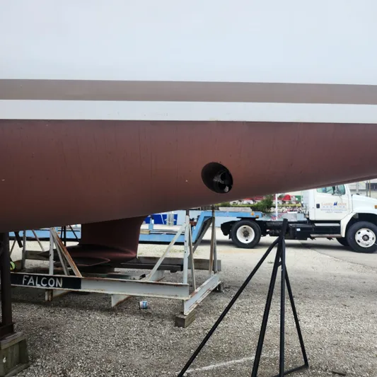 Skye Yacht Photos Pics 2023 Jeanneau Sun Odyssey 349 sailboat hull on dry dock, with visible propeller.