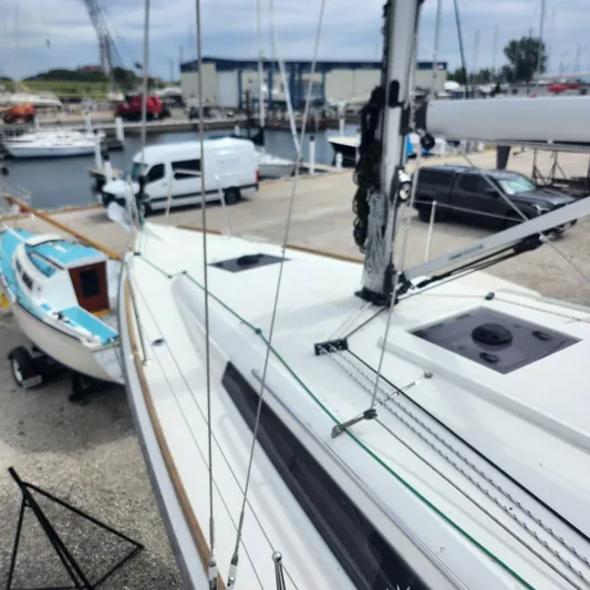 Skye Yacht Photos Pics 2023 Jeanneau Sun Odyssey 349 sailboat docked at marina, showcasing sleek design and rigging.